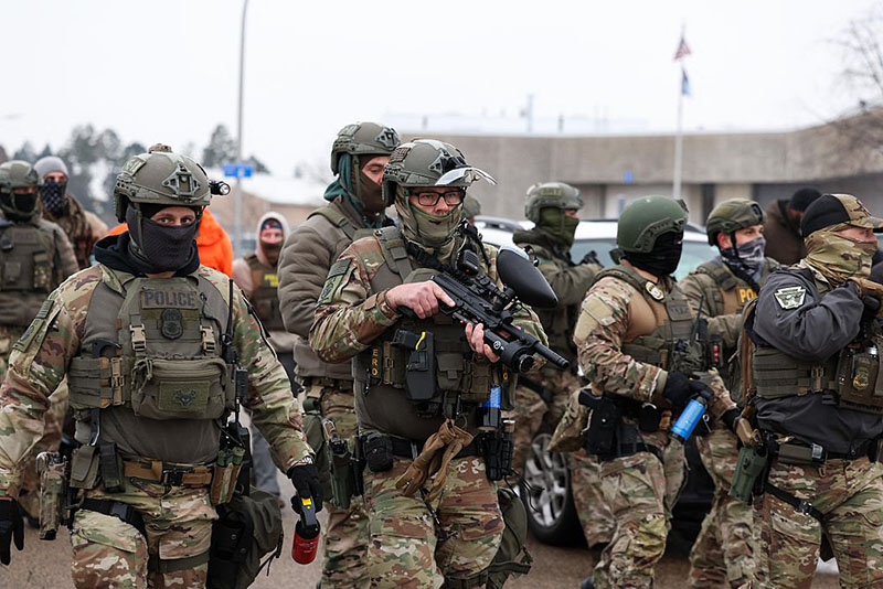 US Border Patrol agents holding less-lethal weapons stand guard at the Bishop Henry Whipple Federal Building in Minneapolis, Minnesota, on January 8, 2026. (Photo by CHARLY TRIBALLEAU / AFP via Getty Images)