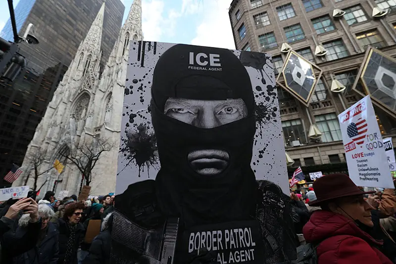 A person holds sign as they participate in a protest organized by Rise and Resist against US Immigration and Customs Enforcement (ICE) activities and the US intervention in Venezuela in New York on January 11, 2026. (Photo by TIMOTHY A. CLARY / AFP via Getty Images)