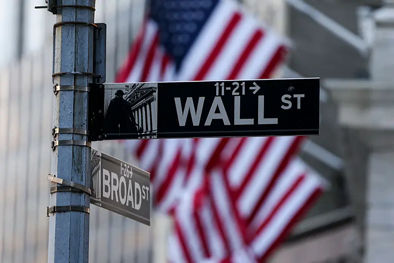 A Wall Street sign hangs near the New York Stock Exchange (NYSE) in New York on January 12, 2026. (Photo by ANGELA WEISS / AFP via Getty Images)